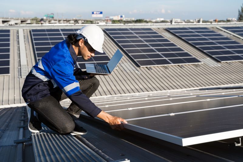 Technician Installing Solar Panels